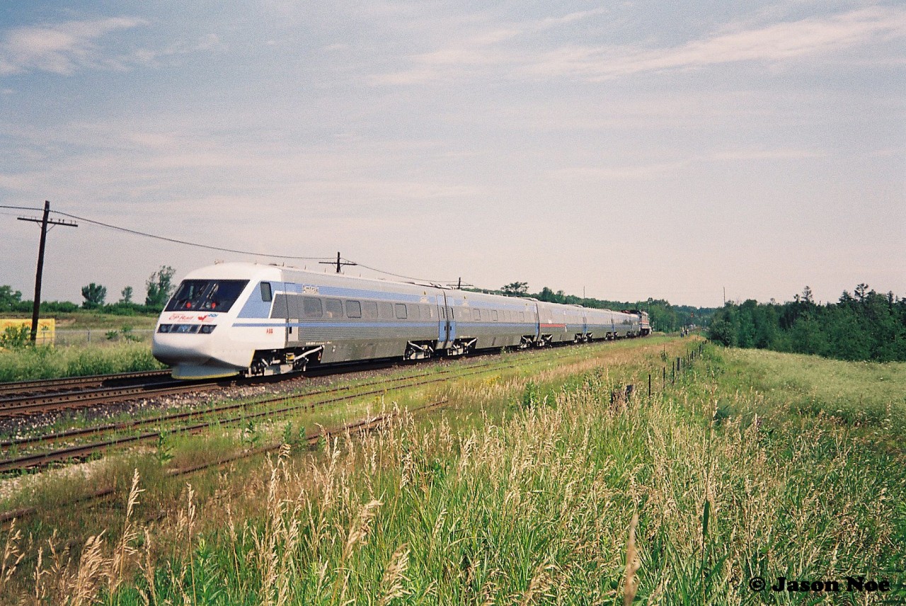 In summer 1993, my first trip to CP Guelph Jct. ironically wasn’t to photograph a CP train, but rather a promotional passenger train set. So the story goes, in July of that year CP sponsored the tour of the X2000, which was a Swedish State Railways train set built by Asea Brown Boveri (ABB) on their lines in Quebec and Ontario. The week-long promotional tour of the two provinces then followed several months of testing and display of the train in the United States by Amtrak. The Toronto portion of the tour was followed by two X2000 excursions to Guelph Junction and return via the Galt Subdivision.
I forget exactly how we found out about it, which was likely through word of mouth at the time, but my dad, myself and a friend arrived at Guelph Jct. ahead of the train’s arrival and immediately realized we weren’t the only ones there. Many other railfan’s, the media and everyone else in between were there to take in the event as well as the crew of the CP local to Guelph, which was powered by an RS18u. For a 13-year-old kid just learning how the mainline’s in Southern Ontario worked, there was so much to absorb let along a futuristic passenger train. I snapped many photos on my small Kodak camera of the train that day and in the end only a few really turned out not too bad.

Here the X2000 train is seen departing Guelph Jct. in Campbellville with Amtrak F40-2 380 powering the train eastbound back to Toronto on the Galt Subdivision.