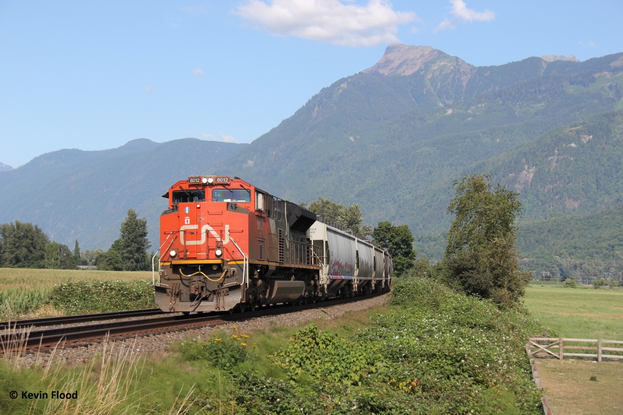 A westbound grain train is pictured hustling towards CN Thornton Yard in Surrey (and elsewhere in the Vancouver area possibly). It is pictured on the approach to Annis Rd. just east of Chilliwack, BC (Mile 66.3 of the CN Yale Sub). We had a car this particular weekend, so a nice Sunday drive into the mountains a bit was in order. I’m appreciative that my wife and daughter were so patient as I followed these two mainlines paralleling each other on either sides of the Fraser River. All trains I caught were the following: CN power with a solo engine up front and as a rear DPU…didn’t catch a single train with CPKC power (even though I followed the CPKC mainline). It appears CN has trackage rights on the CPKC mainline. There is another bridge called the Mission Bridge in Mission, BC where CN can return to CN rails and vice versa. I don’t know. I still don’t have the Vancouver area railway operations and lines figured out! It is way more complex than southern Ontario.