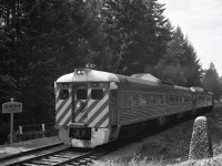 On this day, August 13th, in 1886, Canadian prime minister John A. Macdonald drove the last spike of the Esquimalt & Nanaimo Railway at Cliffside, then around milepost 48 from Nanaimo.  Mileposts were reversed to run northward from Victoria after CP took over 1905-06-08, with Cliffside becoming milepost 25.  In 1958, a stone cairn was constructed to commemorate the 1886-08-13 last spike ceremony.

<p>Ninety-two years after the last spike, on 1978-08-13 during a period of of optimism that CP could be persuaded to continue running E&N passenger service, a re-performance of the last spike ceremony was held with a surprisingly large number of general public attendees, and the northward passenger train (running Passenger Extra since it was a Sunday and the operating timetable had not been updated to reflect the 1978-07-28 introduction of Sunday service) paused briefly for the ceremony at a time (0911 PDT) astonishingly close to the the reported “shortly after 9:00 a.m.” of the original occasion, although the original was on Standard Time.

<p>Southward the same day, there was no crowd, allowing a composition including the cairn and the fresh CLIFFSIDE station name sign on the flagstop platform as CP 9067 + 9103 running as Passenger Extra South passed at 1621 PDT.