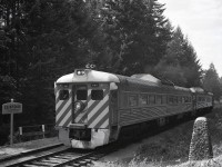 On this day, August 13th, in 1886, Canadian prime minister John A. Macdonald drove the last spike of the Esquimalt & Nanaimo Railway at Cliffside, then around milepost 48 from Nanaimo.  Mileposts were reversed to run northward from Victoria after CP took over 1905-06-08, with Cliffside becoming milepost 25.  In 1958, a stone cairn was constructed to commemorate the 1886-08-13 last spike ceremony.

<p>Ninety-two years after the last spike, on 1978-08-13 during a period of of optimism that CP could be persuaded to continue running E&N passenger service, a re-performance of the last spike ceremony was held with a surprisingly large number of general public attendees, and the northward passenger train (running Passenger Extra since it was a Sunday and the operating timetable had not been updated to reflect the 1978-07-28 introduction of Sunday service) paused briefly for the ceremony at a time (0911 PDT) astonishingly close to the the reported “shortly after 9:00 a.m.” of the original occasion, although the original was on Standard Time.

<p>Southward the same day, there was no crowd, allowing a composition including the cairn and the fresh CLIFFSIDE station name sign on the flagstop platform as CP 9067 + 9103 running as Passenger Extra South passed at 1621 PDT.