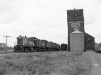 For CP to reach Prince Albert from its northern mainline across Saskatchewan at Lanigan, it took 25.5 miles on CP rails to reach CN’s northern mainline near Humboldt, 1.3 miles on CN from Hulan to Orlebar, 67.6 more on CP to reach CN’s Tisdale sub. at Northway, and then a final  seventeen more CN miles to get to Prince Albert.  On the Tisdale sub., CP had a daily-except-Sunday timetable schedule of No. 85 west and No. 86 east, and this is No. 85 with RS-23s 8020 + 8013 + 8026 + 8025 “rocketing” (so called for their distinct turbo exhaust) past the elevator at CN Davis at 1223 CDT on Friday 1981-09-25, with just over seven CN miles to go.