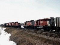 Freight meet on an early spring morning.  The snow is receding; a preview to the usual drabby looking ground once it is gone. At least the railroad activity is interesting.  Eastbound #50 with switchers CP 8144, 8145, 8164 and 8150 meets westward CP 5520 and 5552 just to the east of the Guelph Jct station. All locos now gone from the CP roster.