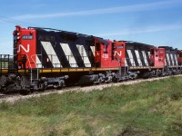 The wheat symbol on the first box gives away this train. They had a quite a bunch of them too, 20 or more on the headend. Then a string of grain hoppers. That is the 4000 back there helping out. Not too uncommon, those rebuilds did turn up on occasion. Photo taken at mile 26.6, mid-afternoon.