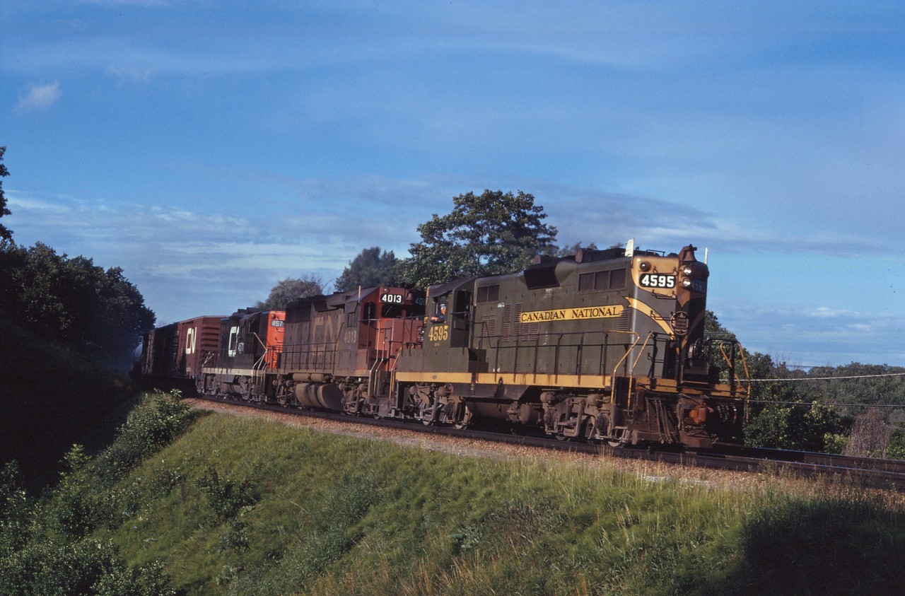 The 4595 was one of the last GP9s in the "old colours" around southern Ontario. Here she leads a westbound freight through Bayview on a beautiful summer evening in 1970, accompanied by GP40 4013 and another GP9 (4571). After a level crossing accident on the Dunville sub in August 1971, she would be rebuilt without the dynamic brake "blister" and continue in service into the early 1990s (rebuilt to slug 273 in 1993).
