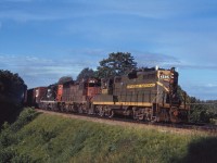 The 4595 was one of the last GP9s in the "old colours" around southern Ontario. Here she leads a westbound freight through Bayview on a beautiful summer evening in 1970, accompanied by GP40 4013 and another GP9 (4571). After a level crossing accident on the Dunville sub in August 1971, she would be rebuilt without the dynamic brake "blister" and continue in service into the early 1990s (rebuilt to slug 273 in 1993).