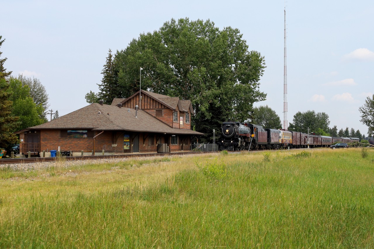 CP 2816 north highballs past the old depot at Okotoks, Alberta.  With no scheduled passenger service anymore, the old station has been transformed into an art gallery and now serves as the perfect backdrop to shoot a steam powered 'passenger' train.