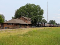 CP 2816 north highballs past the old depot at Okotoks, Alberta.  With no scheduled passenger service anymore, the old station has been transformed into an art gallery and now serves as the perfect backdrop to shoot a steam powered 'passenger' train.