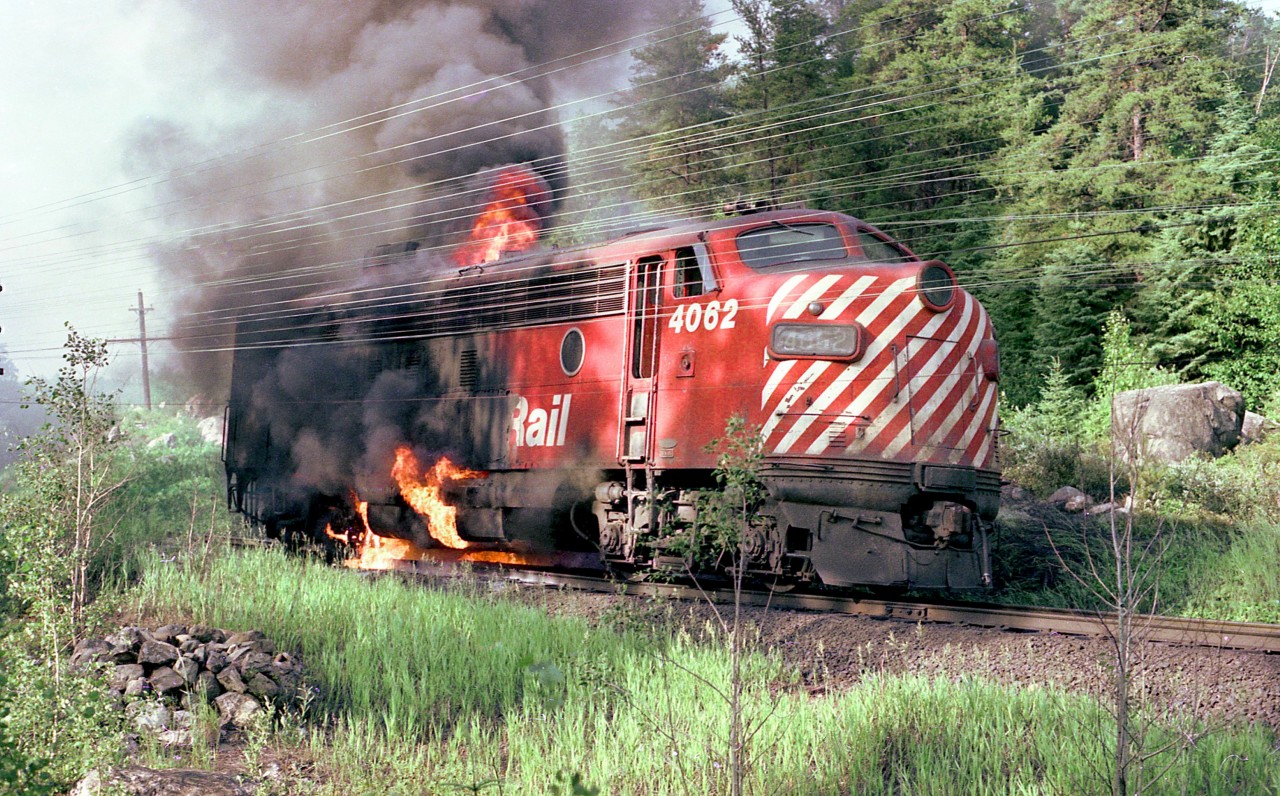 On July 5, 1975 Canadian Pacific FP7 locomotive No. 4062, the third locomotive of westbound Extra 4088 caught fire and was disconnected from the train near mileage 78.5, about two miles east of Franz, Ontario. A Ministry of Natural Resources forest fire suppression crew (including the photographer) was dispatched from Wawa to the scene to prevent the fire from spreading to the adjacent forest.