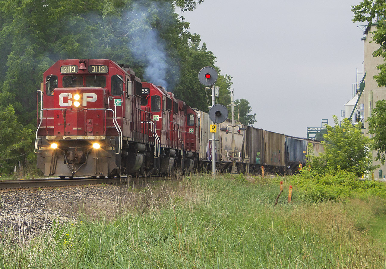 After a slow start to my first attempt at local rail fanning in some time, it just so happened that I was thankful to push myself out the door this Sunday morning. After a brief cruise out to Bloomfield Rd. here in Chatham, I stumbled upon H89 finishing up their switching duties at the ethanol plant. I decided that the best chance to allow myself time to setup and photograph it, was at Kent Bridge. Sure enough, not 5 minutes after I arrived H89 slowly rolled into town. To my luck, they also had duties to switch the sidings at the Anderson's (formerly Thompson's) facility! Here, are the closest thing to the old SD40s...3113 3055 and 3117 perform one of their final moves under the careful eye of the conductor, giving it their all while waking up the sleepy town.