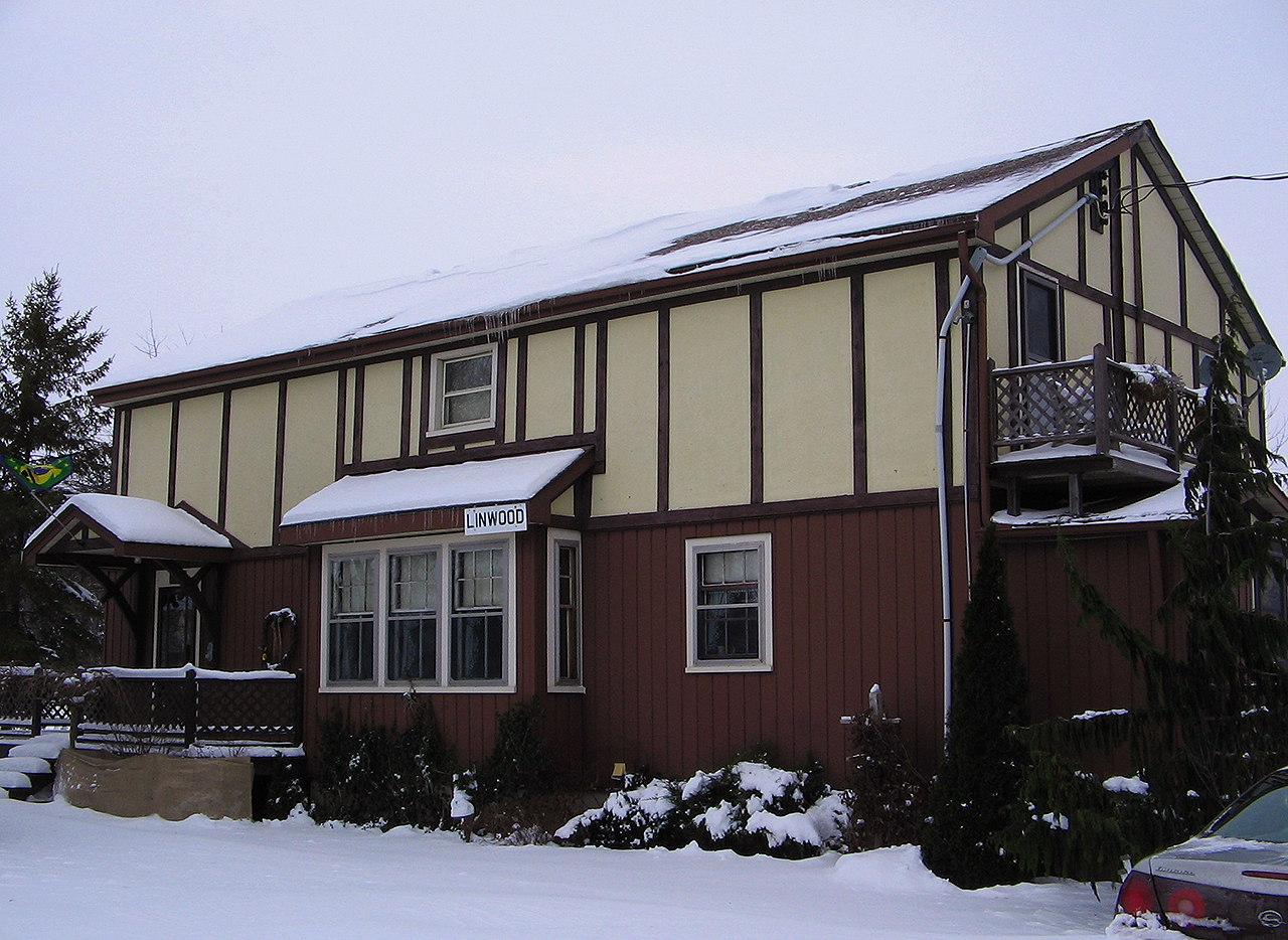 After seeing Jacob Patterson's Linwood Station photo, I was pleased to read that the owner's kept the letter I had left upon my only visit in December 2005. I remember that day well, as it was a very cold and blustery. However, I could not have imagined that this structure was ever a station after it was remodeled into a home, except for the tell tale operators bay window. Although this is two years shy of a time machine photo, you can see how far the building has come. Of note, the freight shed portion of the station was removed and placed on an adjacent property, which would have been located directly behind me. Used for storage, it was in poor shape then...wonder if it still stands now?
