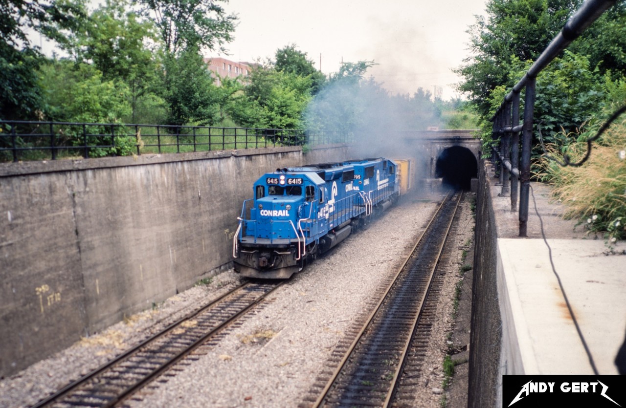 Conrail 6415 and 6705 exit the Detroit River Tunnel in Windsor as they bring a train into Canada in summer 1987.