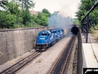Conrail 6415 and 6705 exit the Detroit River Tunnel in Windsor as they bring a train into Canada in summer 1987.