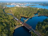 Gorgeous, rugged beauty- summertime in Kenora. CPKC 2/421-16 with CP 8535-KCS 4163 snakes its way out of town, seen rolling over Tunnel Island on the north track, crossing over both inflows of the Winnipeg River where they meet the vast Lake of the Woods.
