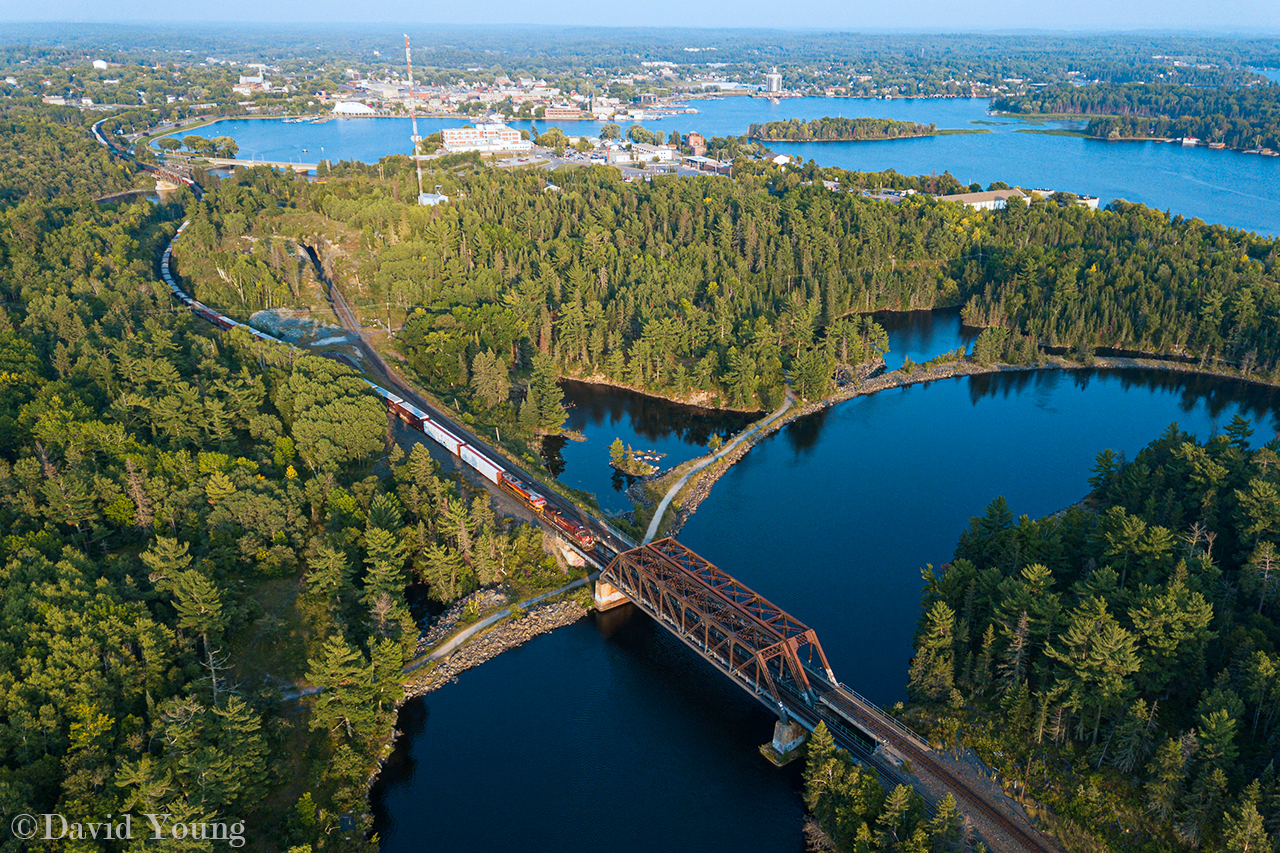 Gorgeous, rugged beauty- summertime in Kenora. CPKC 2/421-16 with CP 8535-KCS 4163 snakes its way out of town, seen rolling over Tunnel Island on the north track, crossing over both inflows of the Winnipeg River where they meet the vast Lake of the Woods.