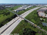VIA Rail F40PH-3D's 6458 and 6436 lead train #1, the Canadian, northbound out of Toronto on the beginning of its transcontinental journey to Vancouver. The consist of two locomotives and stainless steel Budd cars is seen pausing northbound on the Metrolinx (ex-CN) Newmarket Sub over a wide-open Highway 407 ETR (Sunday traffic), awaiting the light to back up onto CN's York Sub, and head east to swing onto the Bala Sub at Doncaster.
