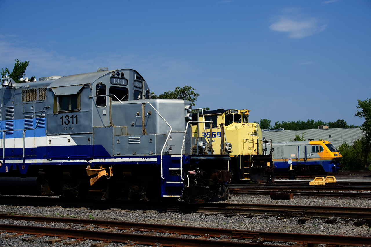 Noses of locomotives built by three different Canadian builders are seen at Exporail: GP9 AMT 133 built by GMD, SLQ 3569 built by MLW and LRC-3 VIA 6921 built by Bombardier.