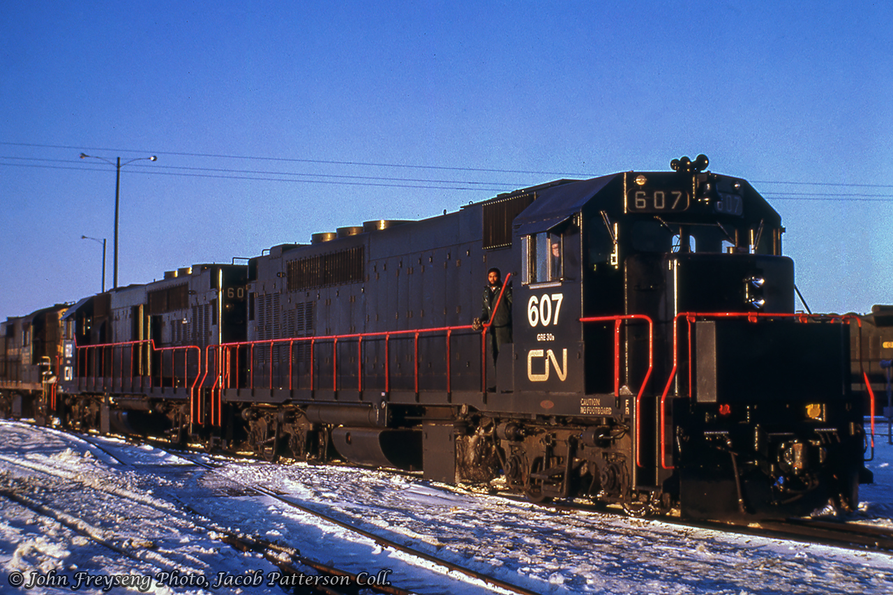 GO Transit GMD GP40TCs 607 and 602 are seen paired with CN RS18 3655 at Toronto Yard's diesel shop in January 1967.  Delivered in late 1966, the eight units numbered 600 through 607, were broken in hauling CN freight trains over the course of a few months.  The units would have their paintjobs modified to official GO Transit colours by April 1967 for final equipment testing before the start of service on Tuesday, May 23, 1967.Doug Page shot these units in freight service on a number of occasions:December 1966, CN 601 eastbound at BayviewDecember 1966, CN 601 eastbound at MiltonMarch 1967, CN 603, CN 607 westbound at BayviewMarch 1967, CN 607 westbound at BurlingtonScan and editing by Jacob Patterson.