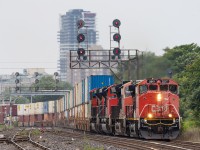 CN 2517, a GE C44-9WL, takes charge of CN 148 as it heads past London Junction on August 6, 2023.  SD70ACe 8102 was the original leader, however it faced PTC issues while the train was stateside.  CN 3031 was added on later, and eventually the 2517 (not PTC equipped) was tacked on in Sarnia.  This was a unique scenario, and seeing a Canadian cab leading 148 is certainly uncommon.  

The train is heading under one of the several signal gantries still standing in London, all original and still holding the vintage searchlight signals.  I have always taken the opportunity to incorporate these artifacts into my shots when possible.  