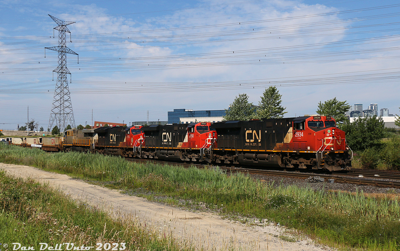 A four-pack of GE's lead CN intermodal #107 shortly after its departure from Brampton Intermodal Terminal: CN 2934, 2850, 3176 and 3977 are about to duck under the Newmarket Sub, heading eastbound through the interlocking plant at Snider on the York Sub enroute for the Bala.