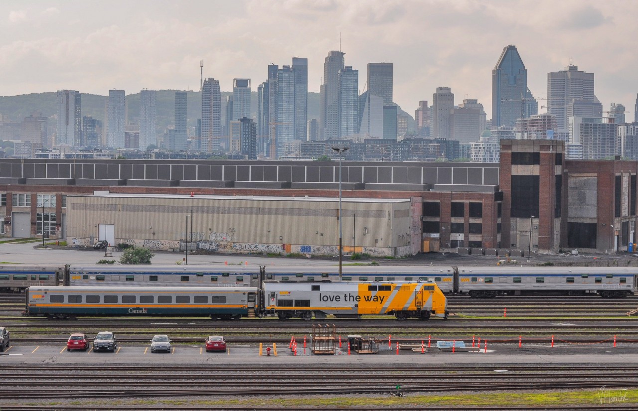 The VIA Rail Maintenance Center, now visible from the REM, with downtown Montreal in the background