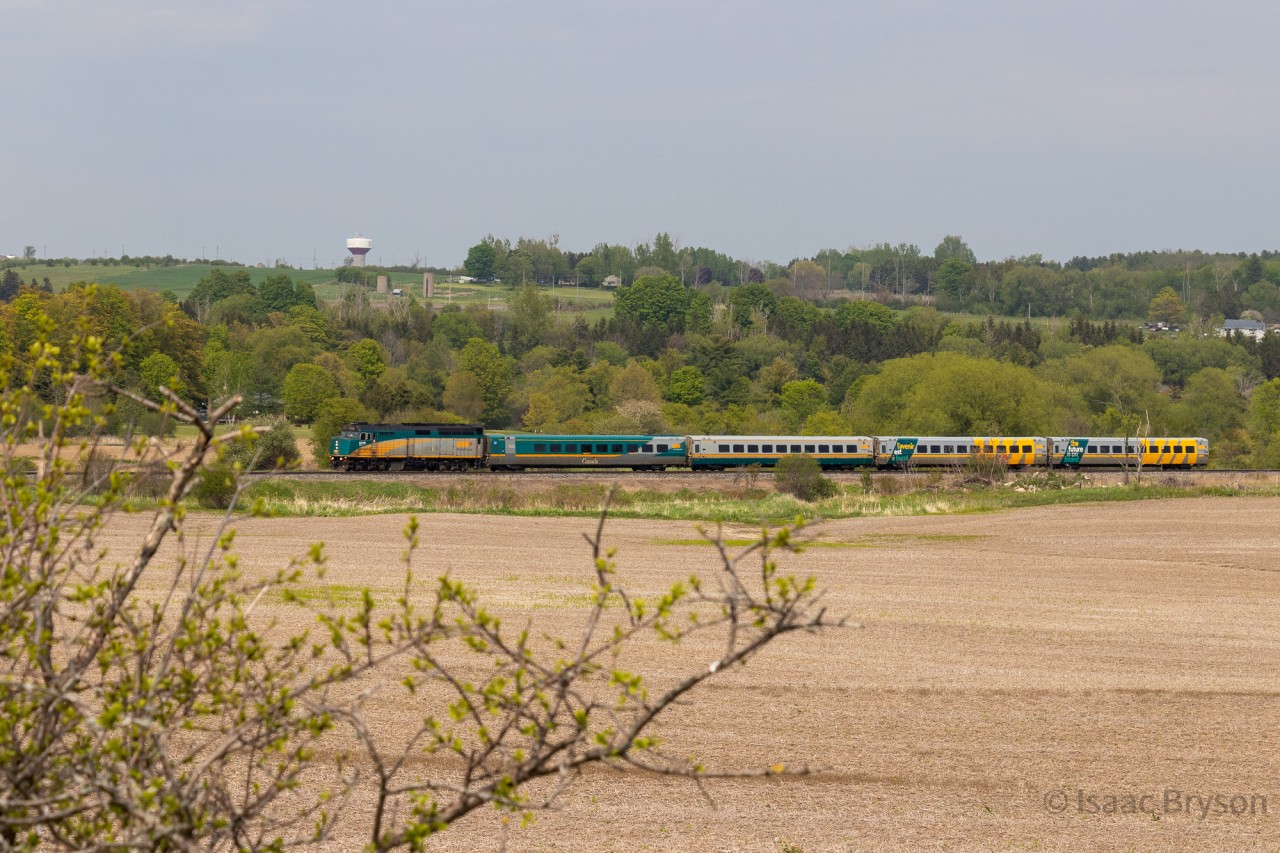VIA 6410 pulls a 4-pack of LRCs through the countryside just west of Port Hope ON. Spring was in the air for this shot, with the buds just starting to grow on the roadside bushes.