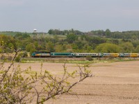 VIA 6410 pulls a 4-pack of LRCs through the countryside just west of Port Hope ON. Spring was in the air for this shot, with the buds just starting to grow on the roadside bushes. 