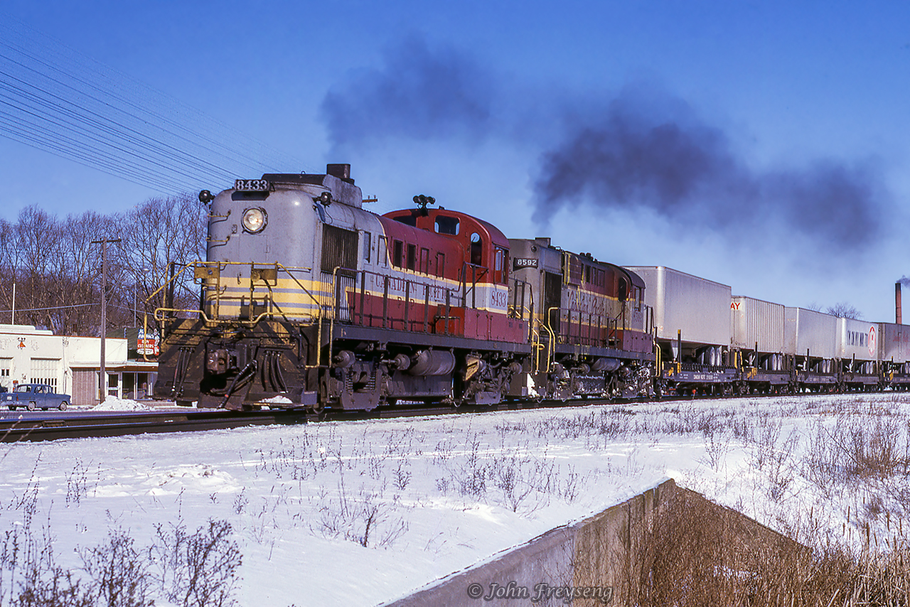 With TOFC traffic on the head end, a pair of first generation MLW products throttle up departing Belleville westbound for Toronto.Scan and editing by Jacob Patterson.