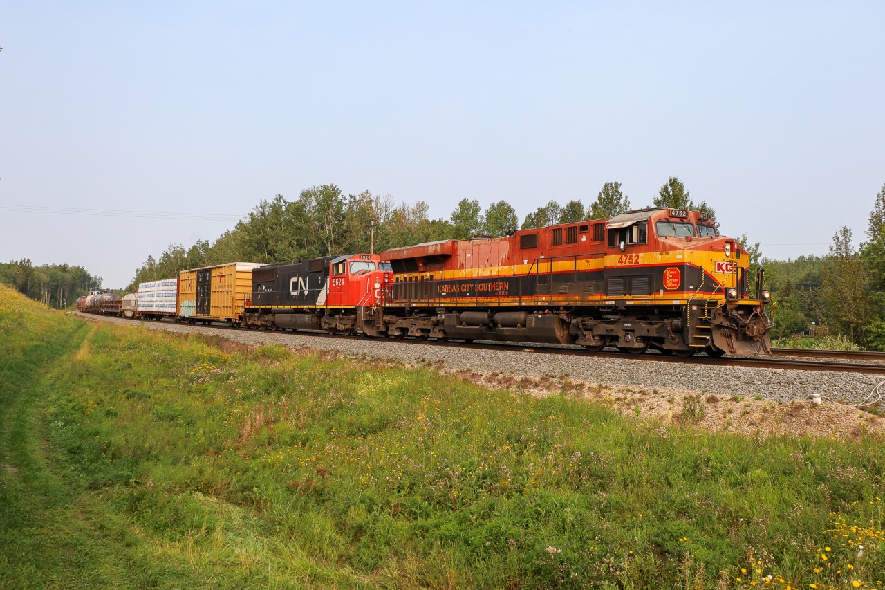 What could have been if the merger went the other way...  M 35651 18 rolls through Stony Plain with KCSM 4752 and CN 5624.