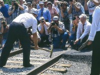 Yes, even some of these fledgling railroads feel the need to celebrate their beginning by hosting a "Last Spike" ceremony.  And this is what we see taking place at the Port Colborne Harbour Railway (now GIO) opening ceremonies back in 1997. Photographers abound, as well as a microphone to record the last 'John Henry' whack to signal the railroad is open for business. On the left in the striped t-shirt is RP'er Greg Smith, flanked by brother and fellow RP'er Rob on the right and father Larry on the left; both intent on documenting this scene for posterity.