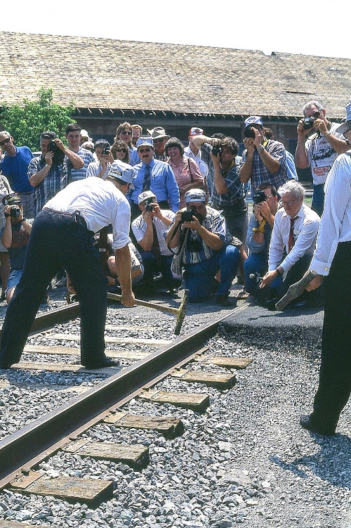 Yes, even some of these fledgling railroads feel the need to celebrate their beginning by hosting a "Last Spike" ceremony.  And this is what we see taking place at the Port Colborne Harbour Railway (now GIO) opening ceremonies back in 1997. Photographers abound, as well as a microphone to record the last 'John Henry' whack to signal the railroad is open for business. On the left in the striped t-shirt is RP'er Greg Smith, flanked by brother and fellow RP'er Rob on the right and father Larry on the left; both intent on documenting this scene for posterity.