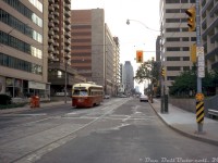 Bustling city streets? Maybe not in midtown Toronto in the 70's: TTC PCC 4545 is surrounded by a valley of apartment buildings and office towers as it heads eastbound on St. Clair Avenue East after departing the nearby St. Clair Subway Station streetcar loop (near Yonge). The PCC is paused at Avoca Avenue before making the short trip over to <a href=http://www.railpictures.ca/?attachment_id=48344><b>Mount Pleasant Avenue</b></a> in order to head north to <a href=http://www.railpictures.ca/?attachment_id=24456><b>Eglinton Loop</b></a>. The "Ryerson Bookstore" signage on the building to the left is likely for the "Ryerson Press" publisher, rather than the polytechnical college/university of the same name. The quiet streets and sun angle suggest a weekend evening photo setting. <br><br>In the interest of furthering density, today a lot of older, smaller office towers like these are being torn down across Toronto for even taller and higher density buildings built on the same parcels of land. <br><br><i>Original photographer unknown (possibly a John Eagle photo), Dan Dell'Unto collection slide.</i>