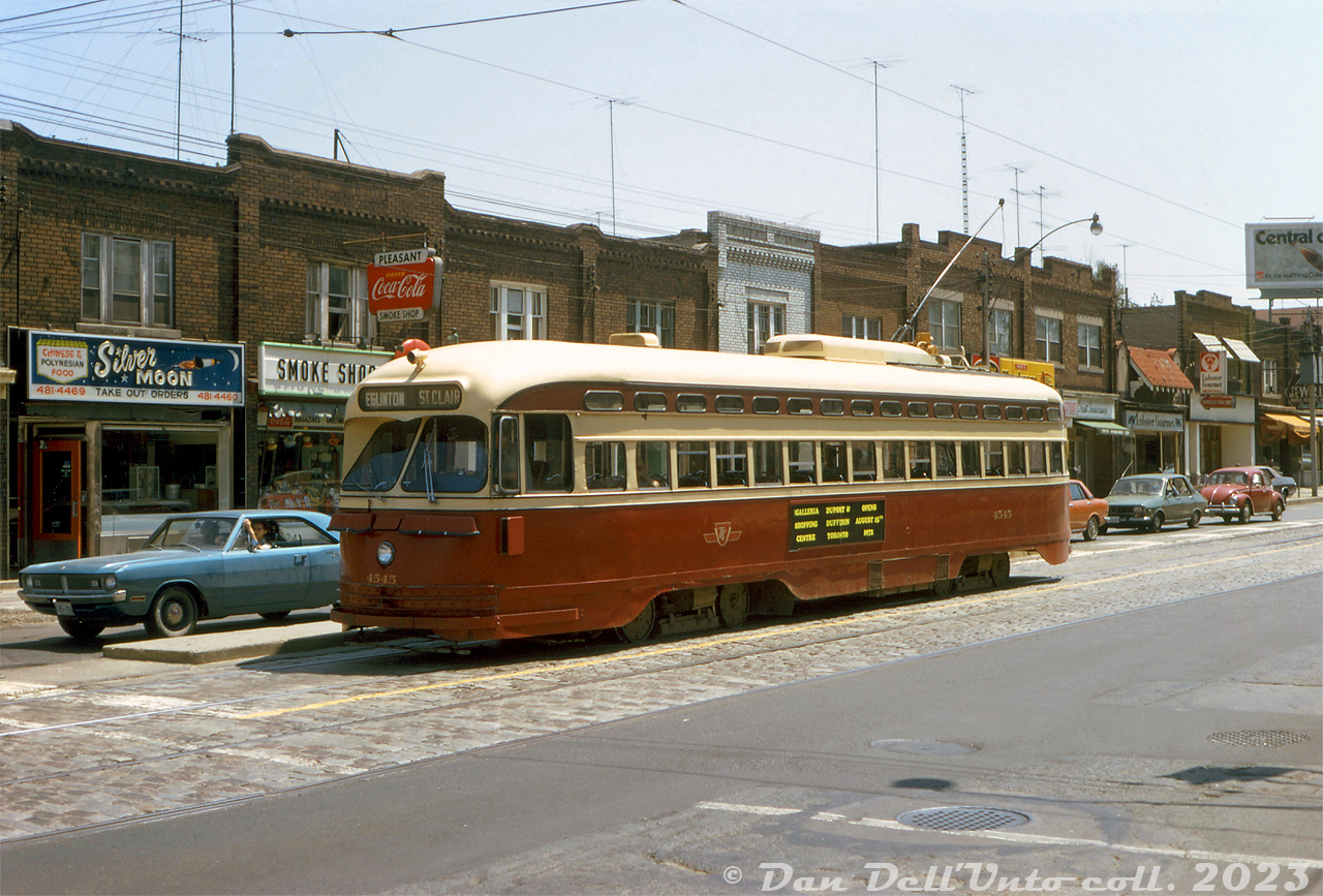 Another view of TTC PCC 4545, likely on the same warm Summer's day as this one, operating on the St. Clair route. This time, 4545 is seen waiting in traffic northbound on Mount Pleasant Avenue at Manor Avenue, on the trip up to Eglinton Loop.

The advertisement on the side of 4545 is for the new Galleria Shopping Centre's grand opening on August 15th, 1972 (closed in 2019). Some of the stores visible in the background are the Silver Moon (Chinese & Polynesian Food), Pleasant Smoke Shop, Pleasant Hardware (Home Hardware franchise?), Lobster Gourmet and Imperial Jewellers. The "Central cooling" ad in the background is advertising Coca Cola as as solution to the heat). Much of this two-story block of stores is still intact today, although streetcar service on Mount Pleasant ended a few years later in late July 1976.

Original photographer unknown (possibly a John H. Eagle photo), Dan Dell'Unto collection slide.