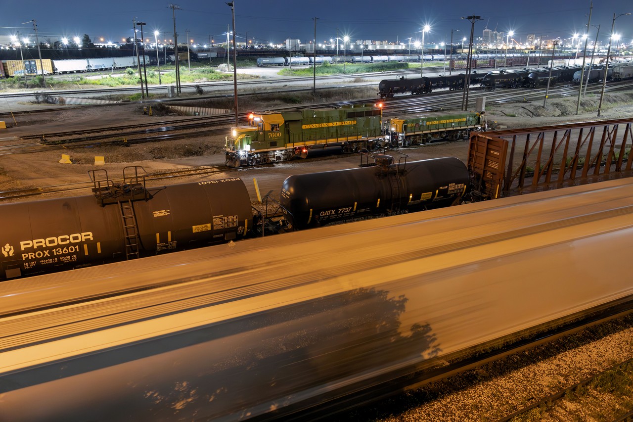 What else do you do on a Friday night but wander Mac yard?

After seeing the heritage set works the visible end of the yard, I decided to walk up and watch it in action. The RC set making several stops in close range giving chance to grab a few shots of the elusive pair wearing CN's original green and gold.