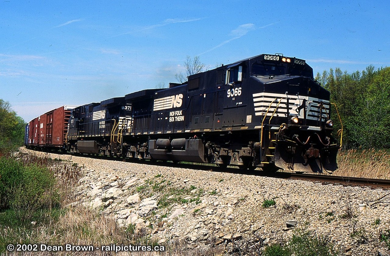 Captured: NS 328 with NS C40-9W 9066 and NS C40-9W 9371 at Mile 15.17 (Yager East) on the CN Stamford Sub at 13:00 on May 23/2002.