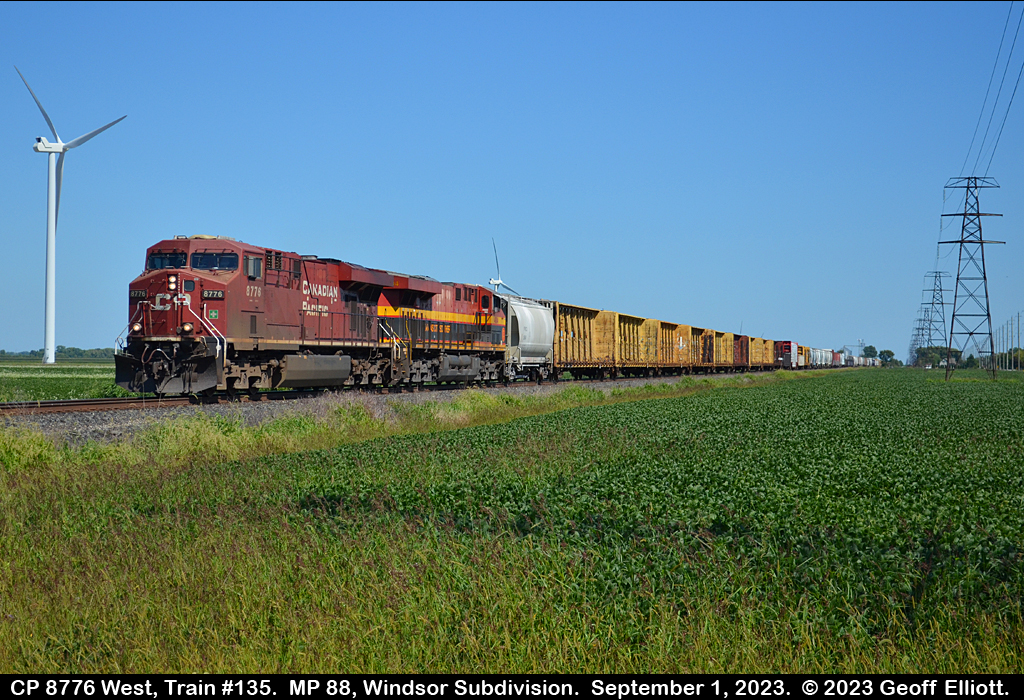 CPKC Train #135, with CP 8776 and KCS 4804 for power, approach the Rochester Townline crossing just east of St. Joachim, Ontario on September 1, 2023.