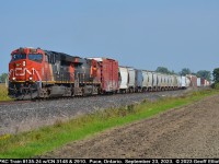 CPKC train 2-135-24 approaches Wallace Line crossing in Puce, Ontario on September 23, 2023.  Today's treat is a pair of CN GE's for 135, compared to the BNSF bonnet the other day.  Seems like you can see pretty much anything on CP lately.