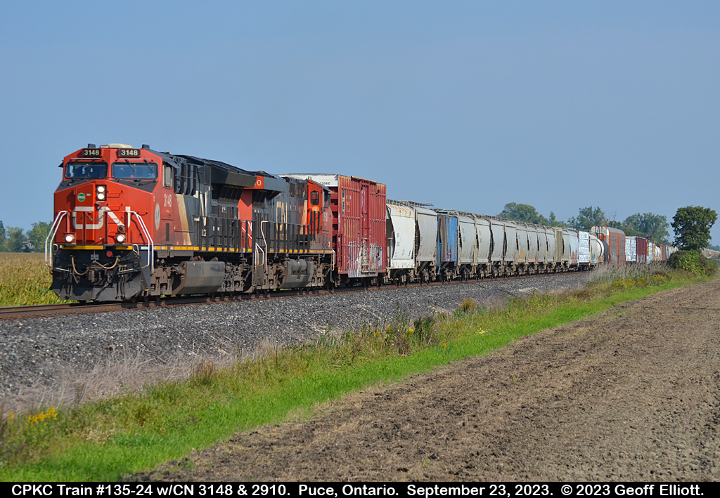 CPKC train 2-135-24 approaches Wallace Line crossing in Puce, Ontario on September 23, 2023.  Today's treat is a pair of CN GE's for 135, compared to the BNSF bonnet the other day.  Seems like you can see pretty much anything on CP lately.