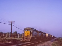 C&O 3029-3034-3031 A trio of GP-30's blasting along west into the sunset, just about to bang over the diamond of the CN Dunnville sub at Canfield Junction. The time I have in my notes, this train went by at 20:00. During the visit to Canfield and E&O we saw a total of 14 trains including CN,C&O,PC,N&W and TH&B. This Kodak Instamatic slide has lasted well after all these years.
 