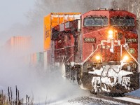 CP 9810 heads east through Colborne as a brief period of sun interrupts the snow squall's blowing in off Lake Ontario.