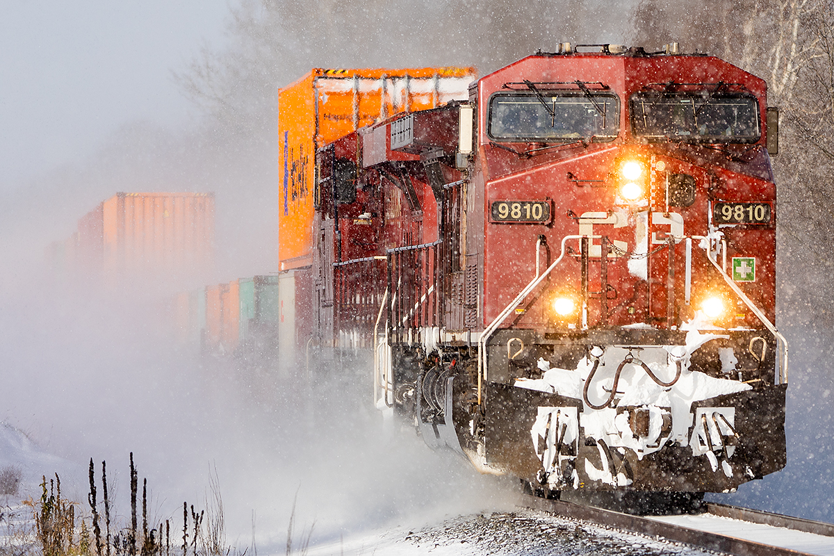 CP 9810 heads east through Colborne as a brief period of sun interrupts the snow squall's blowing in off Lake Ontario.