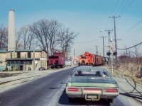 Bruce Lowe captured CP's Simcoe Sub wayfreight along the former Lake Erie & Northern Railway as it crosses Water Street, Highway 24 at the south end of Galt.  On the spur at left is former Canadian National Railway caboose 78444, lettered for the fictitious Nith River, Grand Valley & Southern.  The caboose, owned by a business executive, was used as a private poker room, eventually being relocated to Oakville in 1990.  After bouncing around in private ownership, the trackside guide lists it as surviving on a farm near Elora.