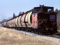 Saturday at 10:30 and the regular crew was close to home. A few miles ahead will be Gibbons, the final town that might have some cars to pickup. The pair of GMD-1's up at the front had 20 hoppers in tow. Sunday's, for this crew was a day off, Monday's, saw them return with tanks of fuel for the air base. Photo taken at mile 23.8.