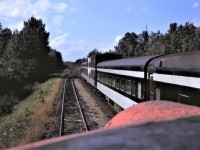 Viewed from the head end of # 3, the tail end of southbound # 4 has some interesting cars.  There appears to be a deadhead coach behind the sleepers, then comes the car-go-rail auto transporter, and finally a business car wearing the markers.  Number 3 is in the siding at the north switch of Woodward siding.  Location shown is approximate. 