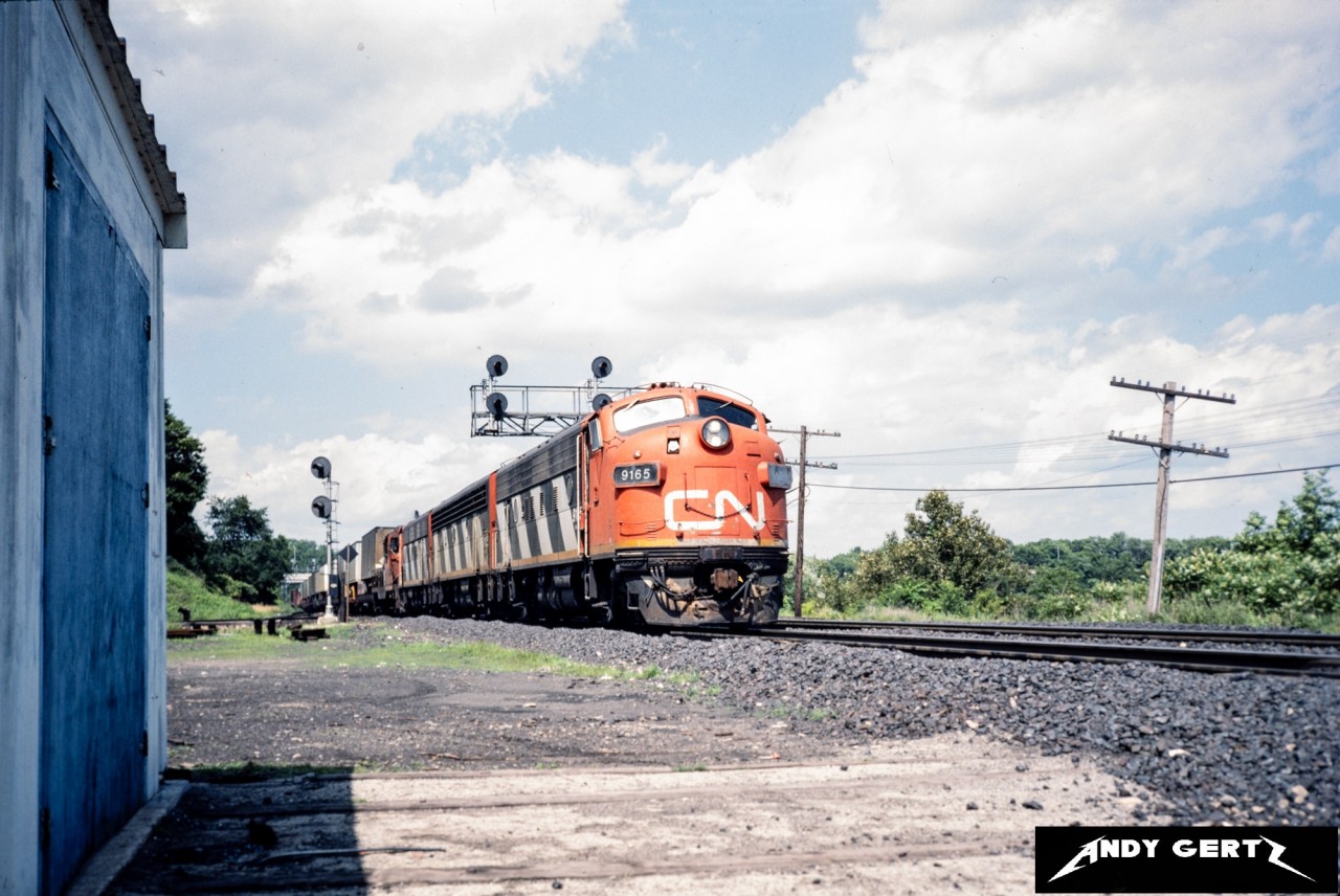 CN 9165 with an A-B-A consist and a Geep head through Bayview Junction with a freight in summer 1986.