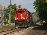 Last September CN performed upgrades to the main crossing in Baden, Ontario on the Guelph Subdivision. Foundry Street was closed for several days until the work was completed and the area around the crossing was heavily clear cut, which opened this view from the typically overgrown vegetation seen there during the summer months. Here, 4705 and 4131 slowly guide L568 over the newly surfaced crossing as foremen look on. 