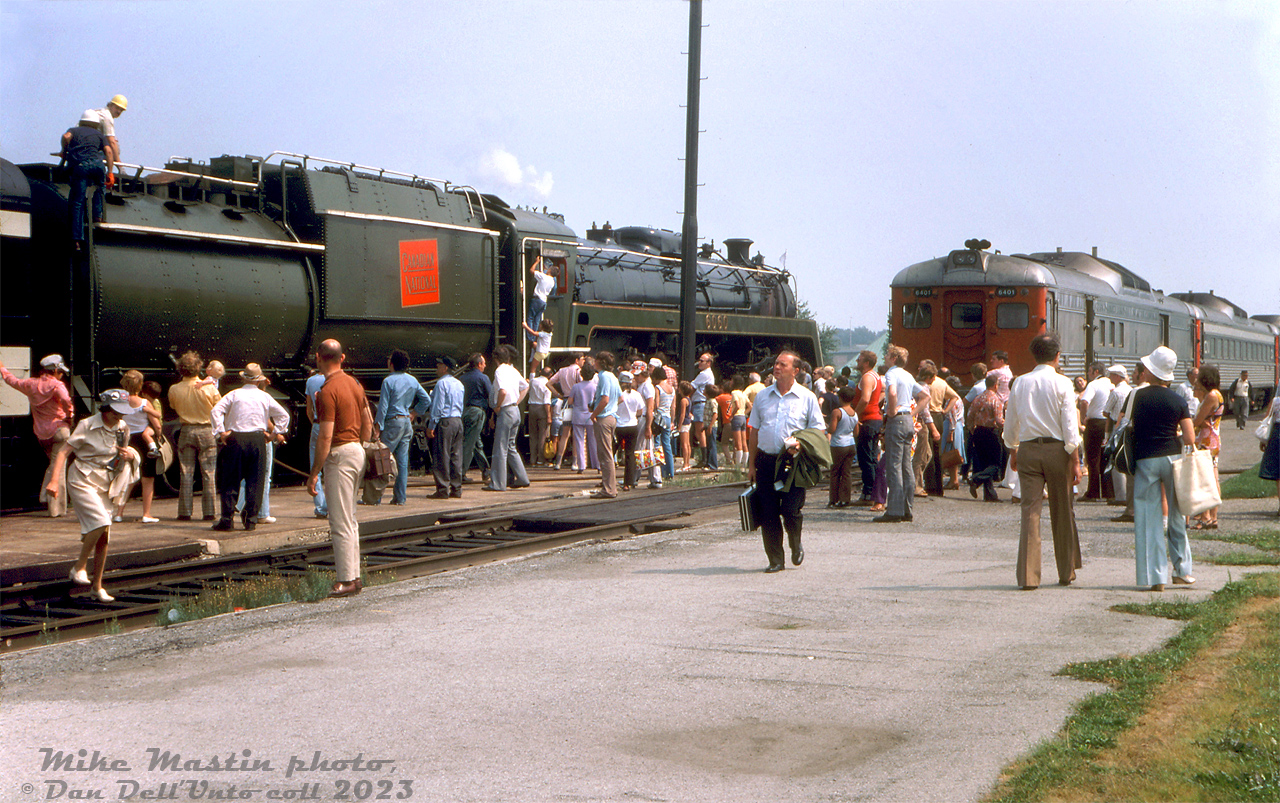 After one of the regular summer steam excursions from Toronto to Niagara Falls, Canadian National "Bullet-nosed Beatty" 6060 sits near station being serviced as passengers crowd the platforms for an up-close and personal look at the big 4-8-2 Mountain (a few even climb up into the cab). CN RDC-4 6401 sits one track over near the station, on one of the regular Toronto-Niagara Falls trains. A rare Budd RDC-4 (one of only 14 made, 6 of which were owned by CN), it doesn't hold a candle to a live steam locomotive.

Mike Mastin photo, Dan Dell'Unto collection slide.