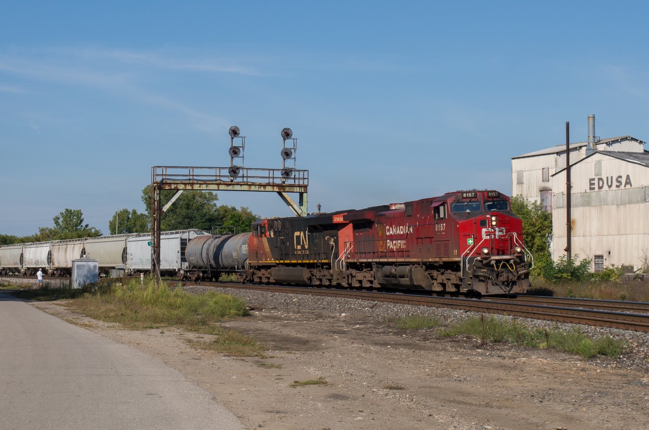 CN 394 passes through Paris Ontario behind CP 8157 and CN 2938 on a sunny September morning.