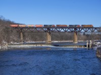 A colourful consist leads M302 across the Grand River at Paris.