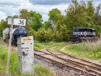 Vintage GP9, CCGX 1000 ("The Pride of Orangeville") has cut off it's train on the main an is nosing into the industrial spur(s) at the west end of town to begin their switching maneuvers. This location was the climax of the famous Tim Horton's commercial filmed during 2001 which aired during the 2002 Winter Olympics, where the train crew pulled up to the nearby Tim Hortons (just out of frame to the right) to grab their coffee.