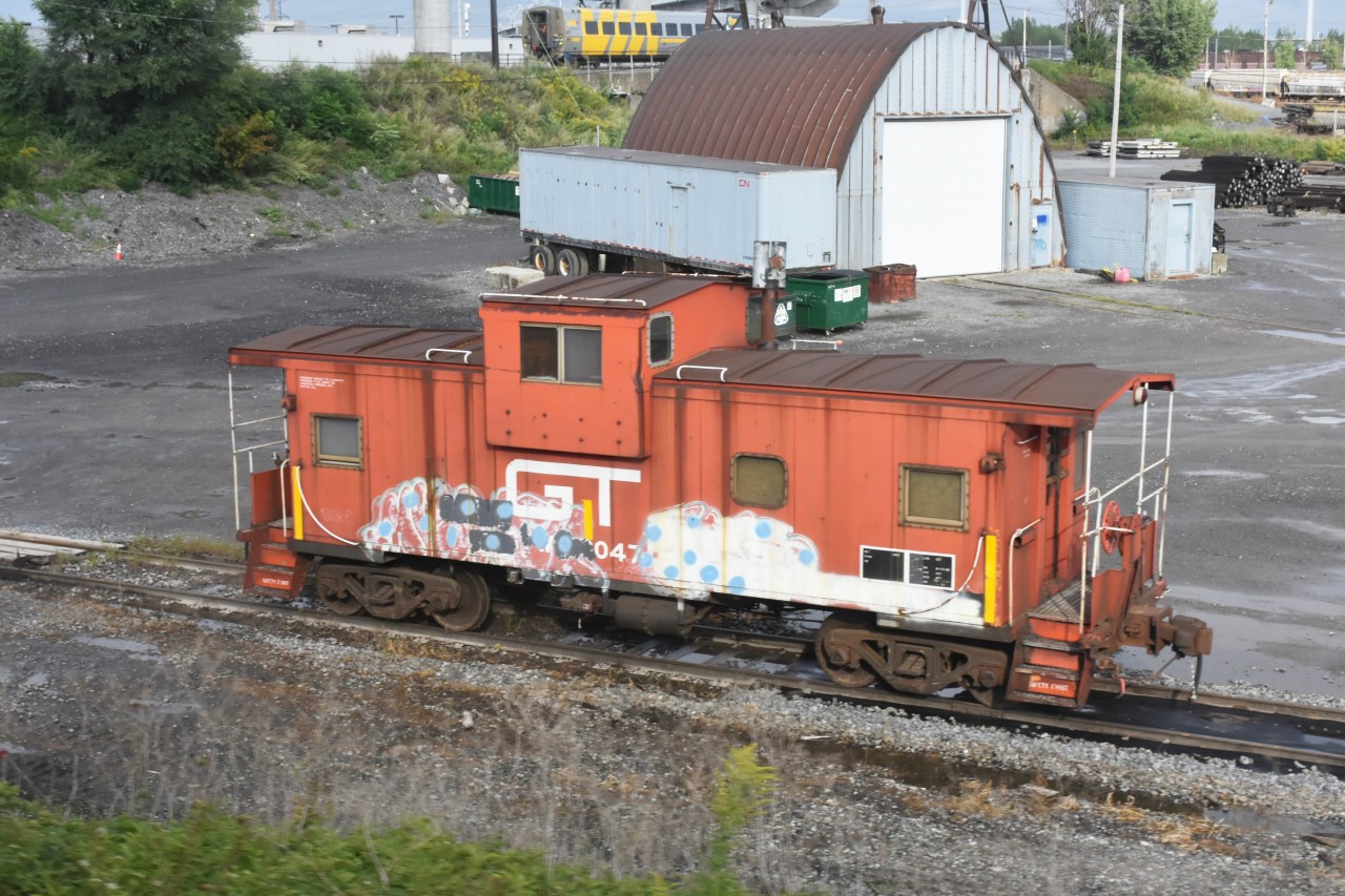 GT 79047 sits at CN Pointe St. Charles, QC waiting for its next assignment as a rider car.